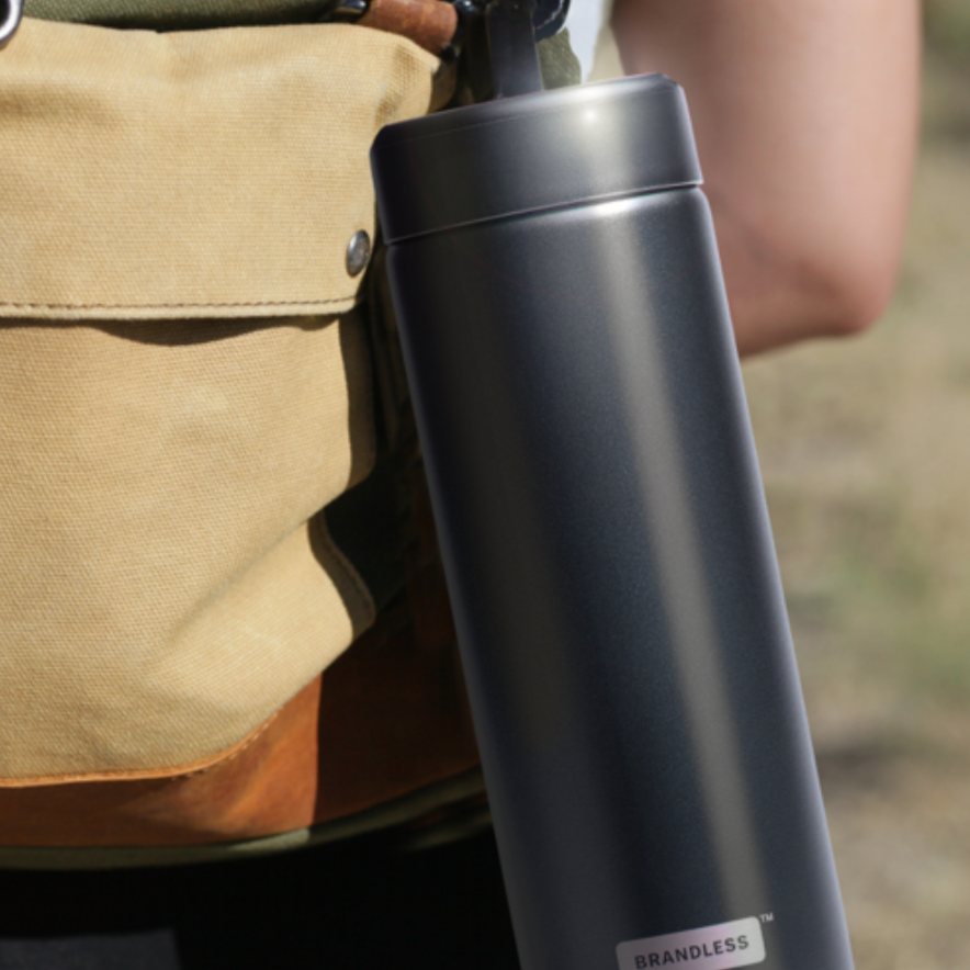 Lifestyle, Brandless stainless steel water bottle clipped to a hiker&#39;s backpack with a caribiner.